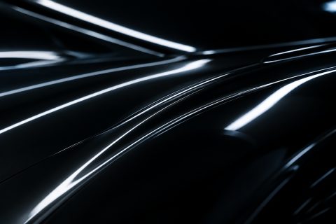 Light reflections running along black bodywork, close up